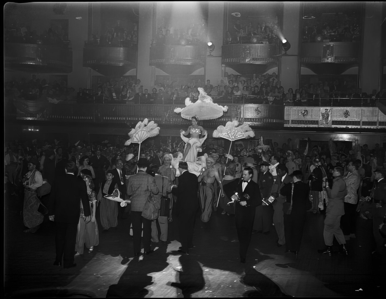 A woman being carried into the party on a litter, 1951.