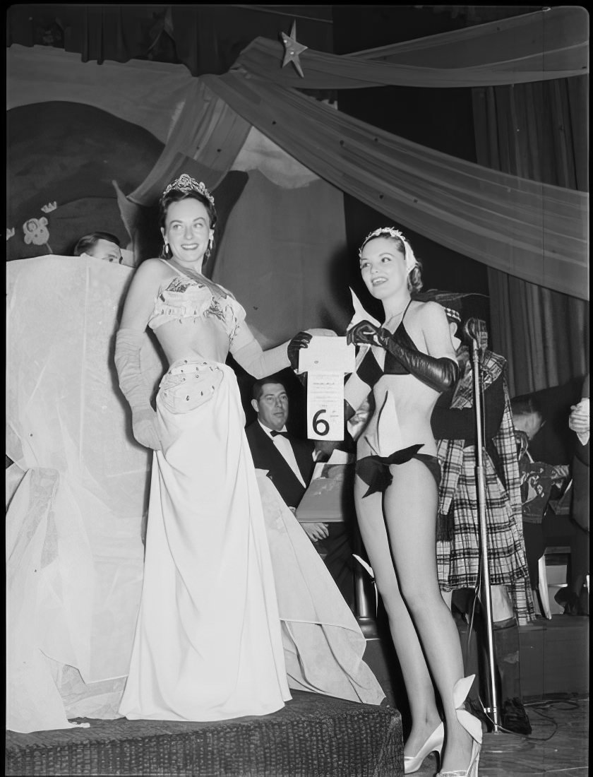 A woman giving another woman the 6th place prize for best costume, 1951.