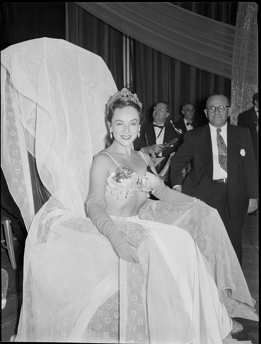 A woman sitting in a chair on stage, 1951.