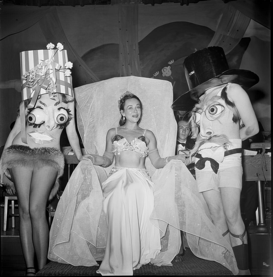 A woman with a costumed man and woman, 1951.