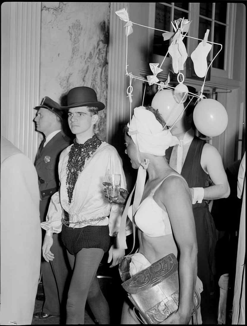 A woman with an elaborate headpiece walking with others in costume, 1951.