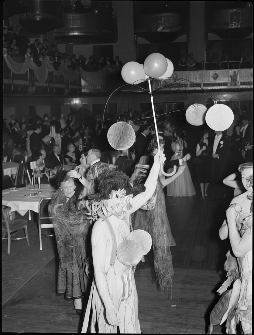 A woman with an umbrella frame decorated with balloons, 1951.