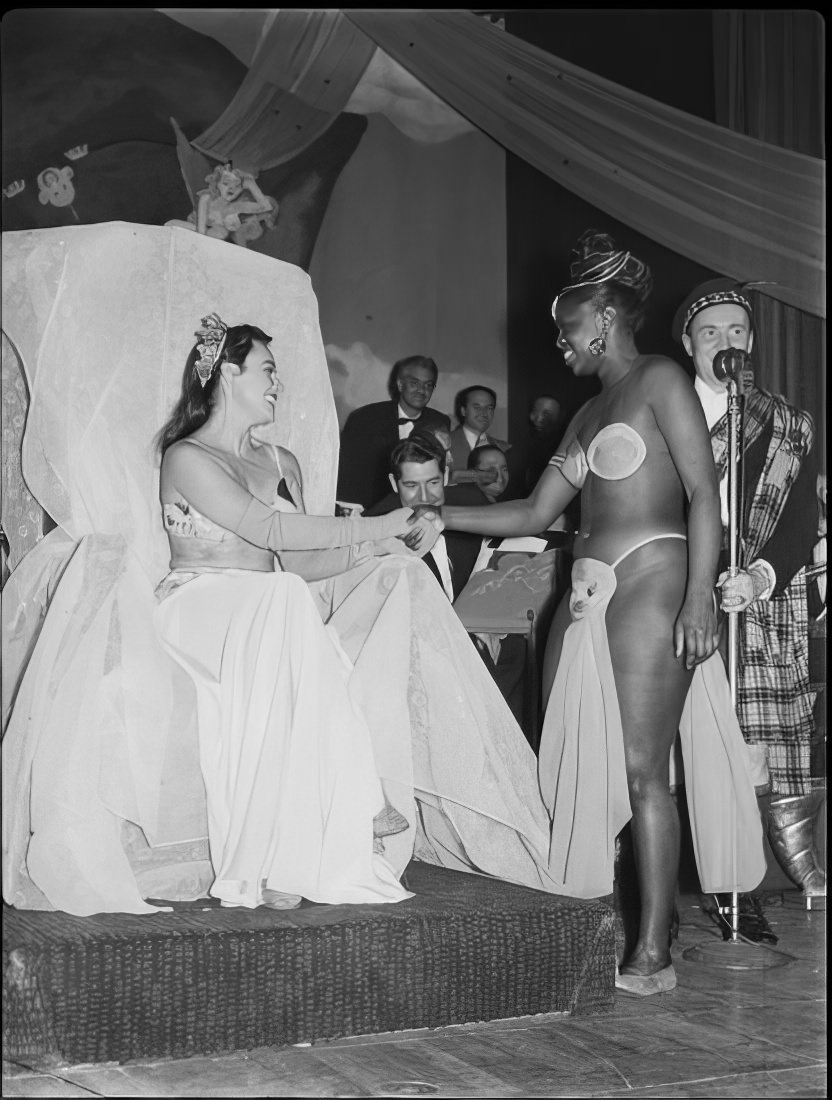 Women shaking hands on stage, 1951.