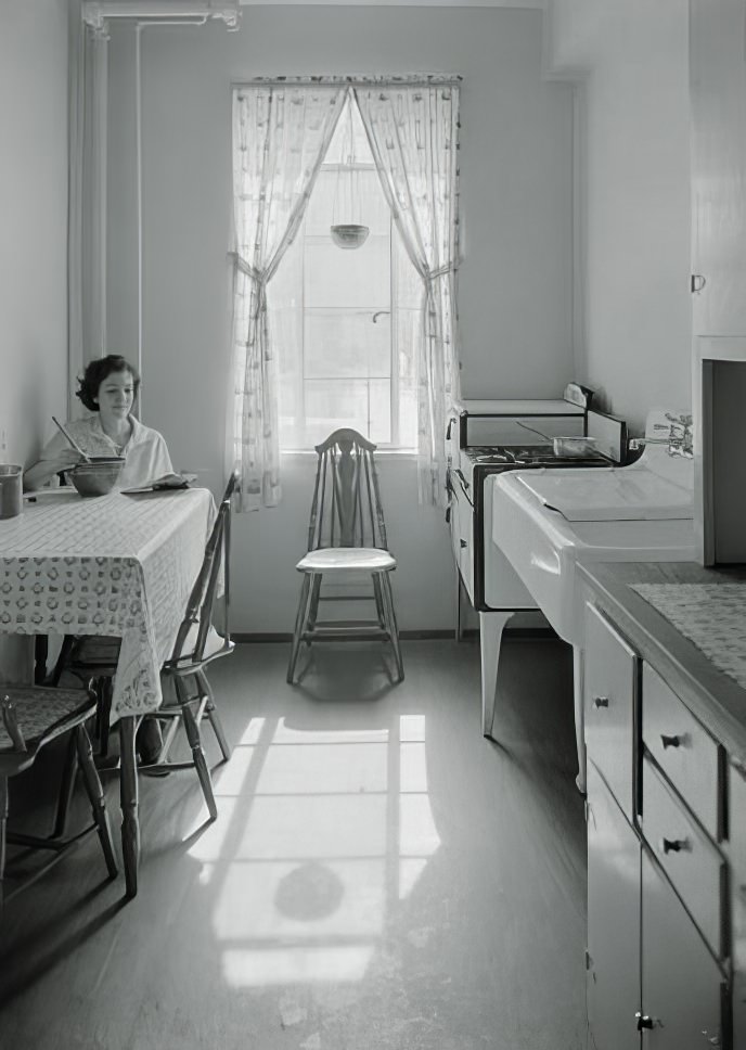 Kitchen with Mrs. Lenninger seated, 1935.