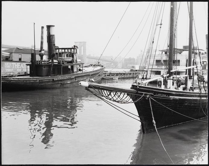 Tugboat and the vessels Robert Fulton and Lettie G. Howard docked at piers 15-17 in the South Street Seaport, 1974.