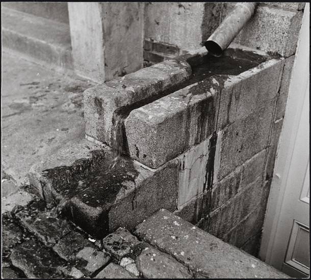 Granite rainbasin at cellar entrance to Bowne & Co. Stationers, 211 Water Street, 1977