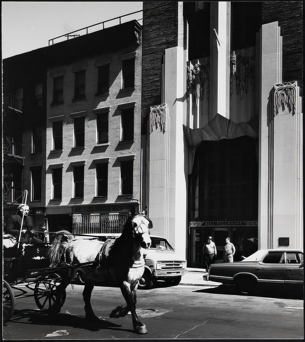 Carriage driver passing the Bell Telephone Building, 435 West 50th Street, 1973