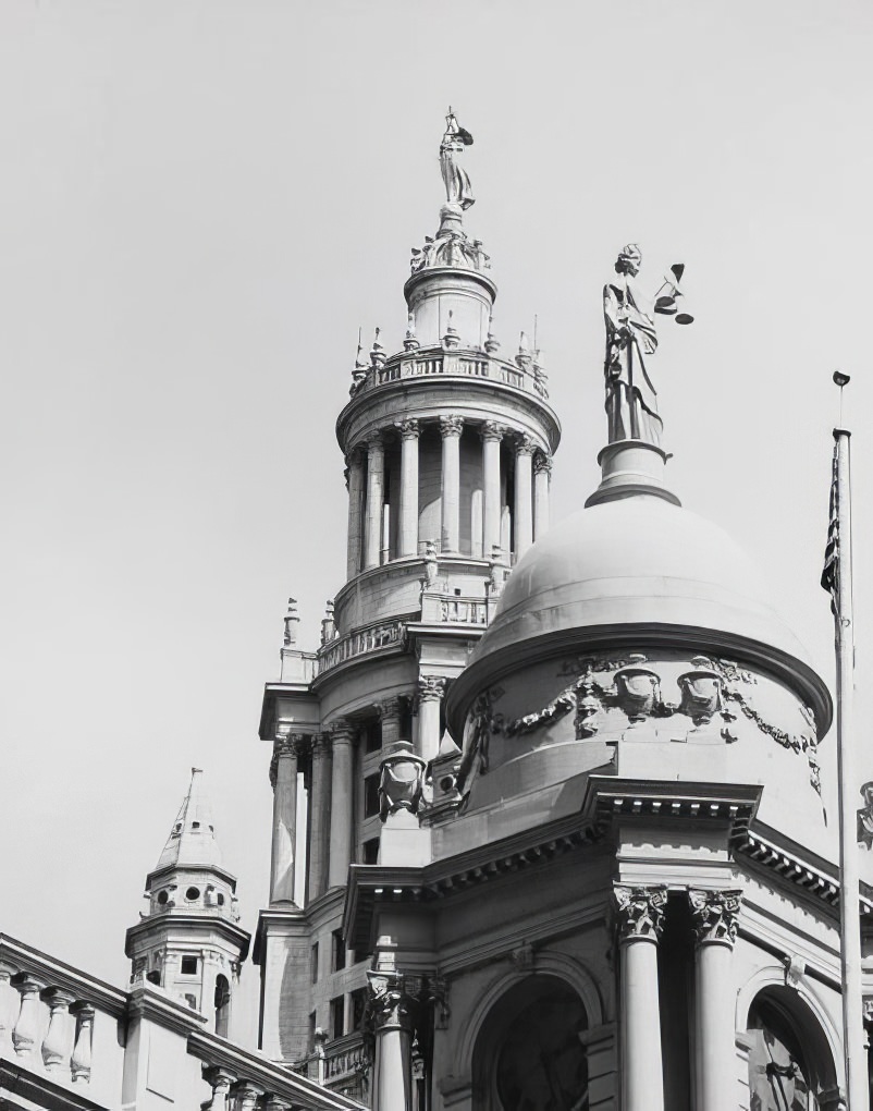 "Justice" statue on City Hall cupola, with "Civic Fame" statue on Municipal Building tower, 1975