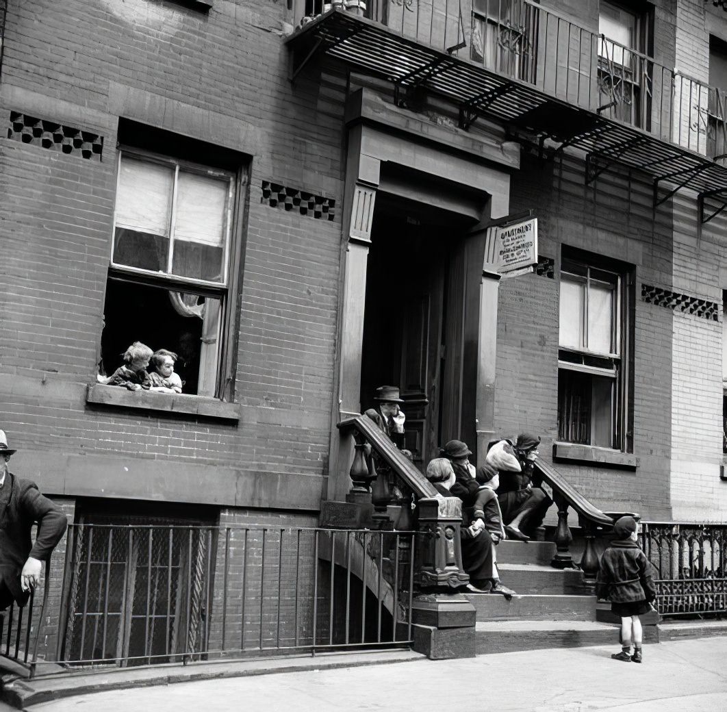 People sitting on a stoop, 1935.