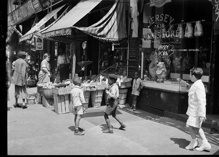 Children in front of the Jersey Pork Store in Harlem, 1939.