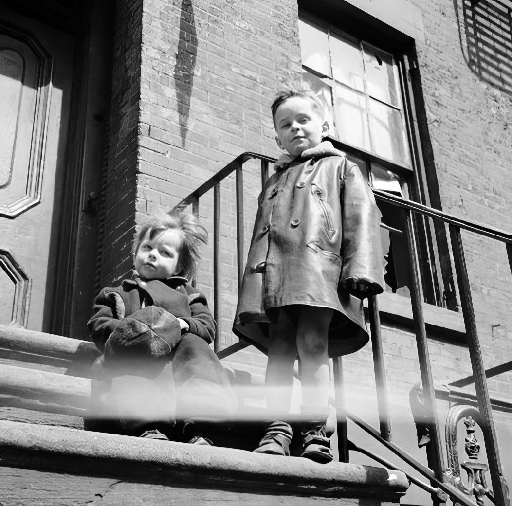 Two children on a front stoop, 1935.