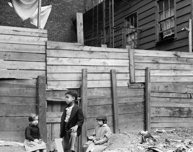 Wooden tenements and children, 1935.