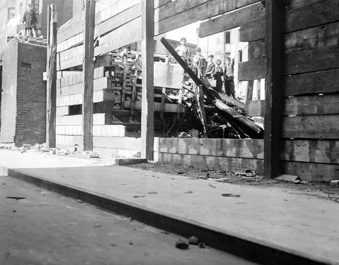 Boys playing in the wreckage of a building, 1938.