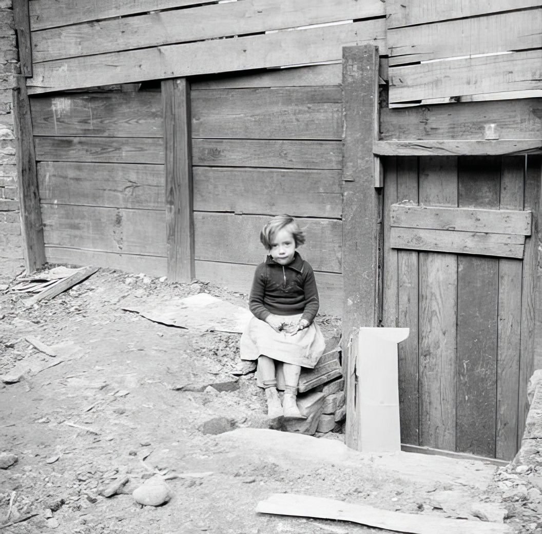 Little girl in a cluttered lot, 1935.