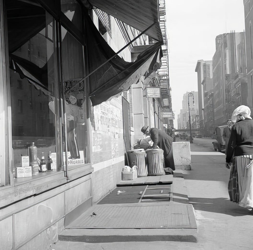 Person and garbage cans, 1935.