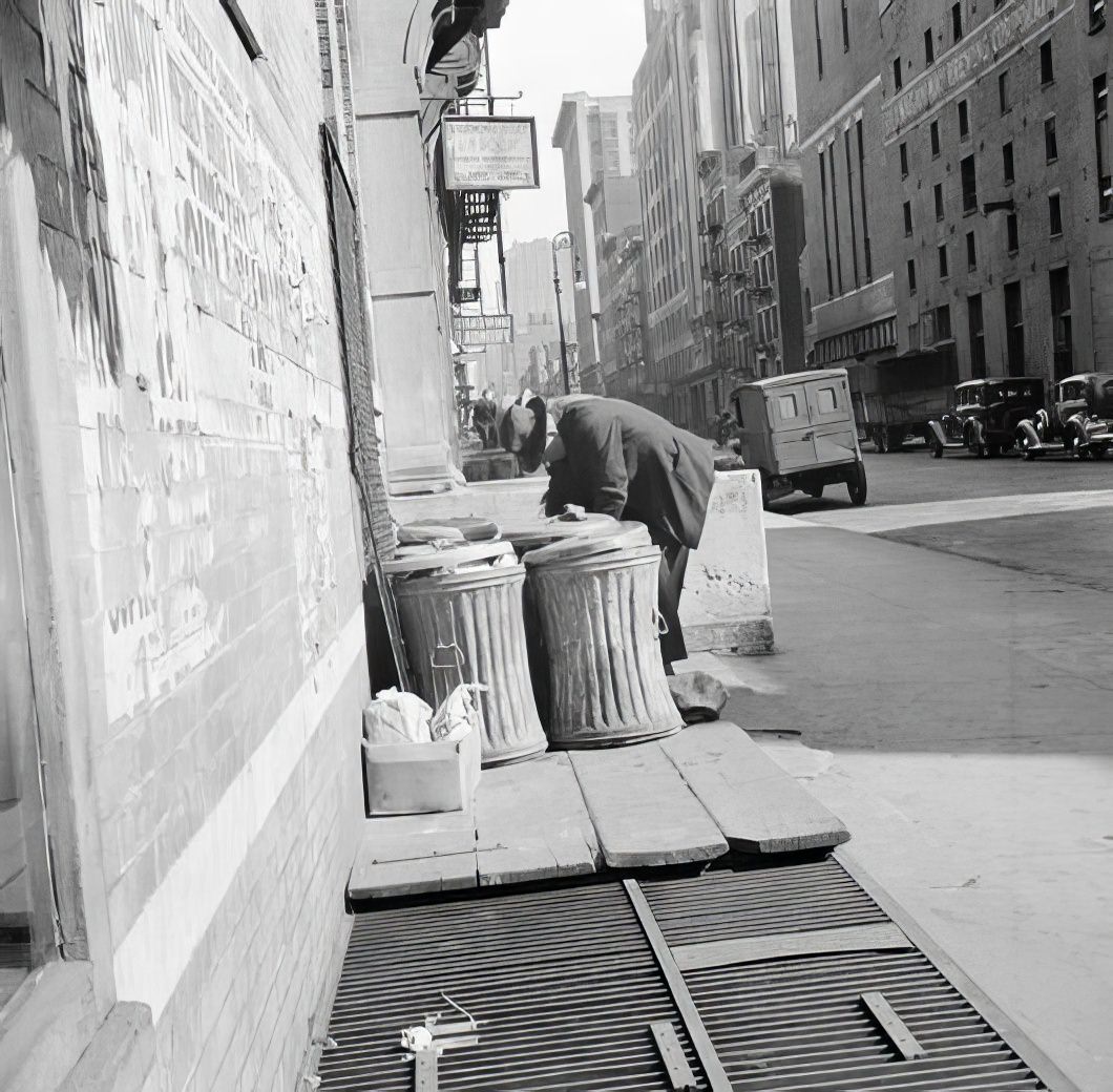 Scavenger at garbage cans, 1935.