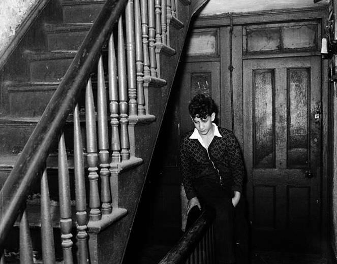 Teenager sitting on a banister, 1935.