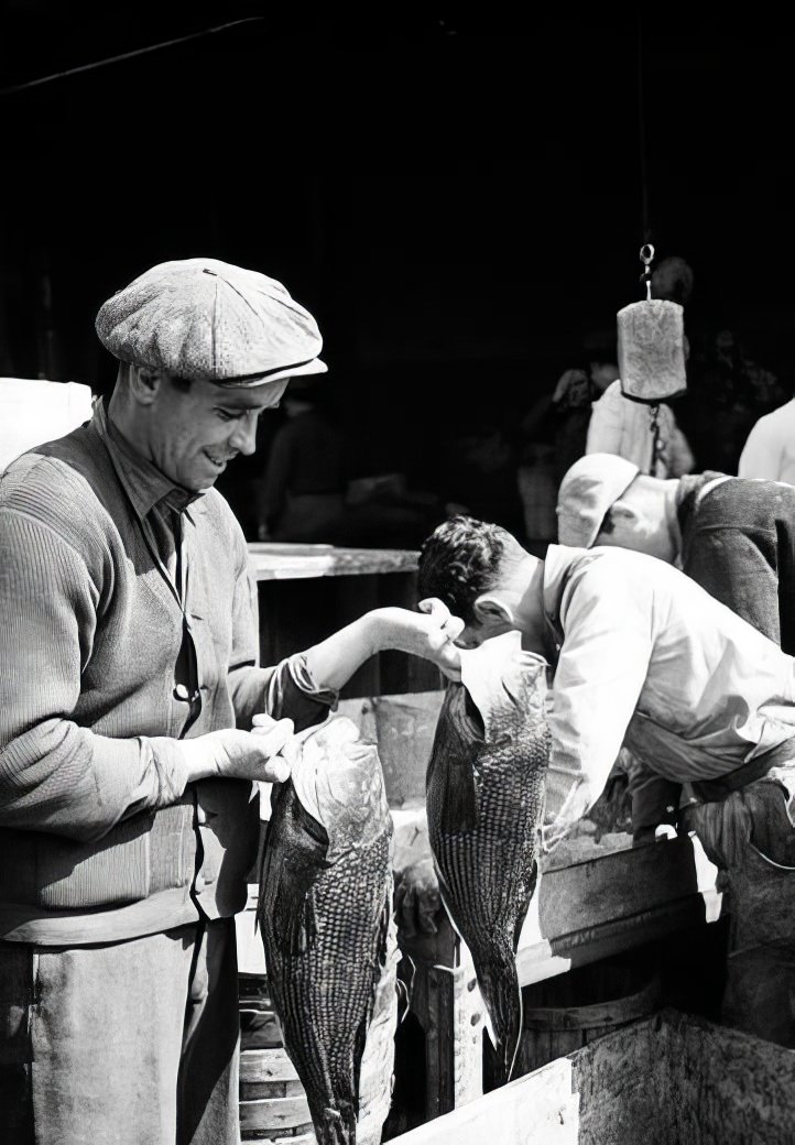 Fulton Street Market: Men with sea bass, 1938