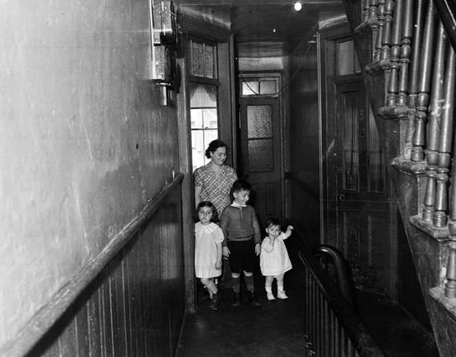 Family in shabby hallway, 1936