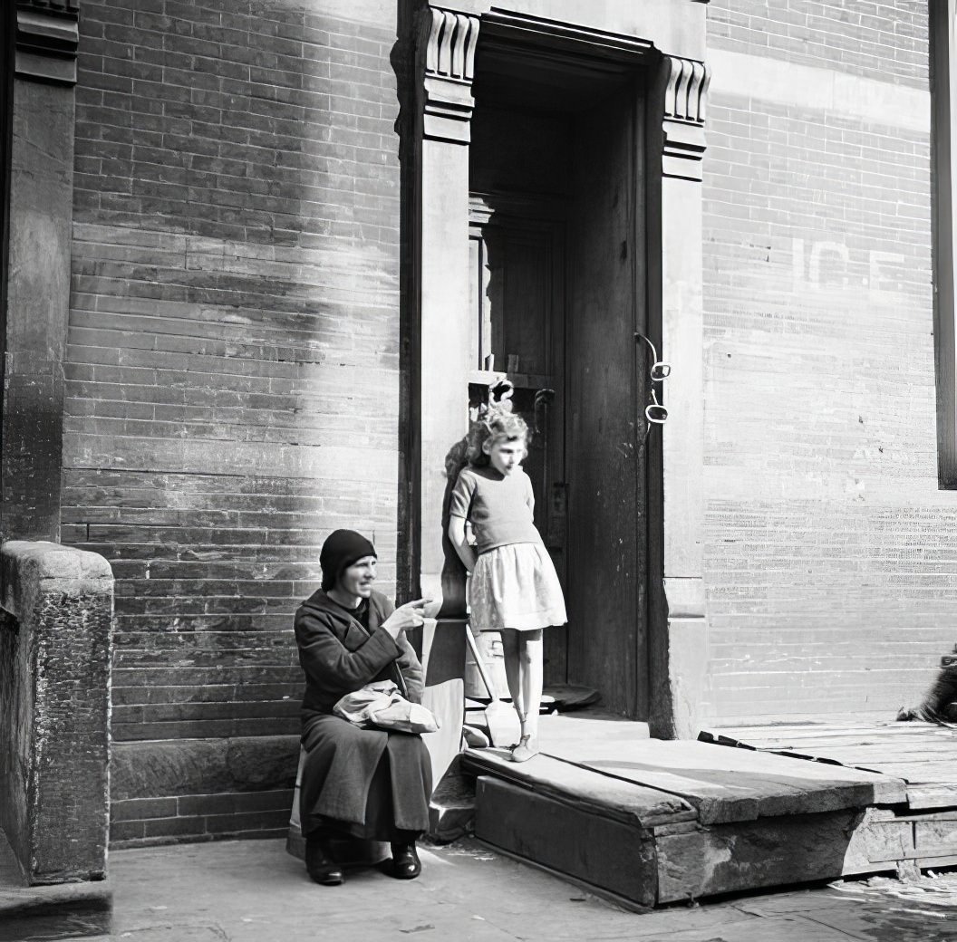 Girl and man on doorsteps, 1936