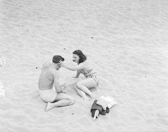 Couple sunbathing, 1939.