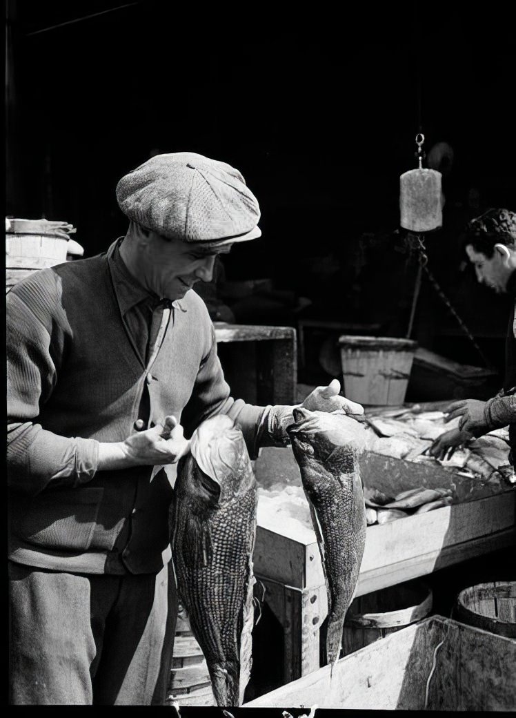 Fulton Street Market: Man with sea bass, 1938