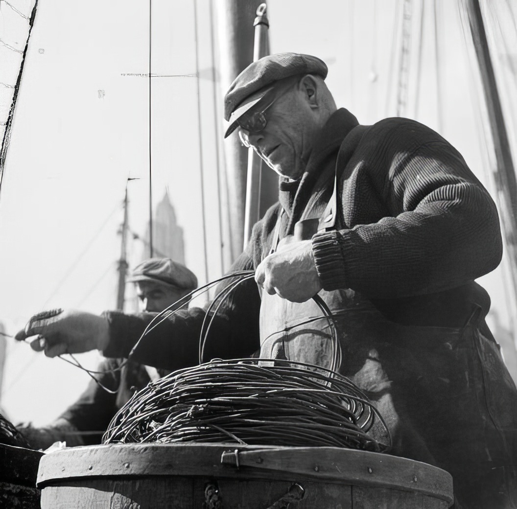 Waterfront scene with a man and a coil of rope, 1937.