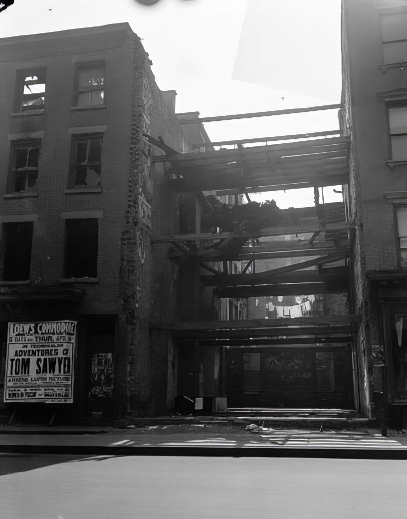 Two houses separated by the beams of a ragged house, 1935