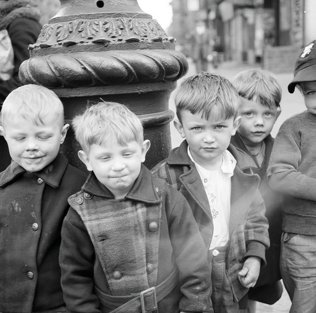 Boys around the base of a lamppost, 1936.