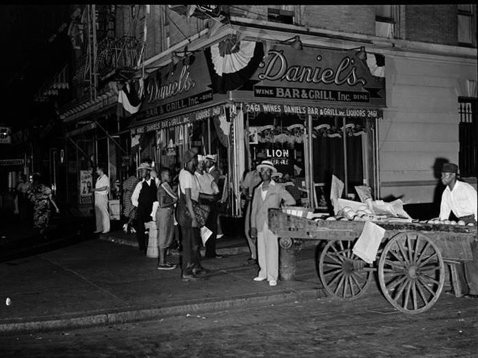 Street scene in Harlem in front of Daniel's Bar and Grill, 1939.