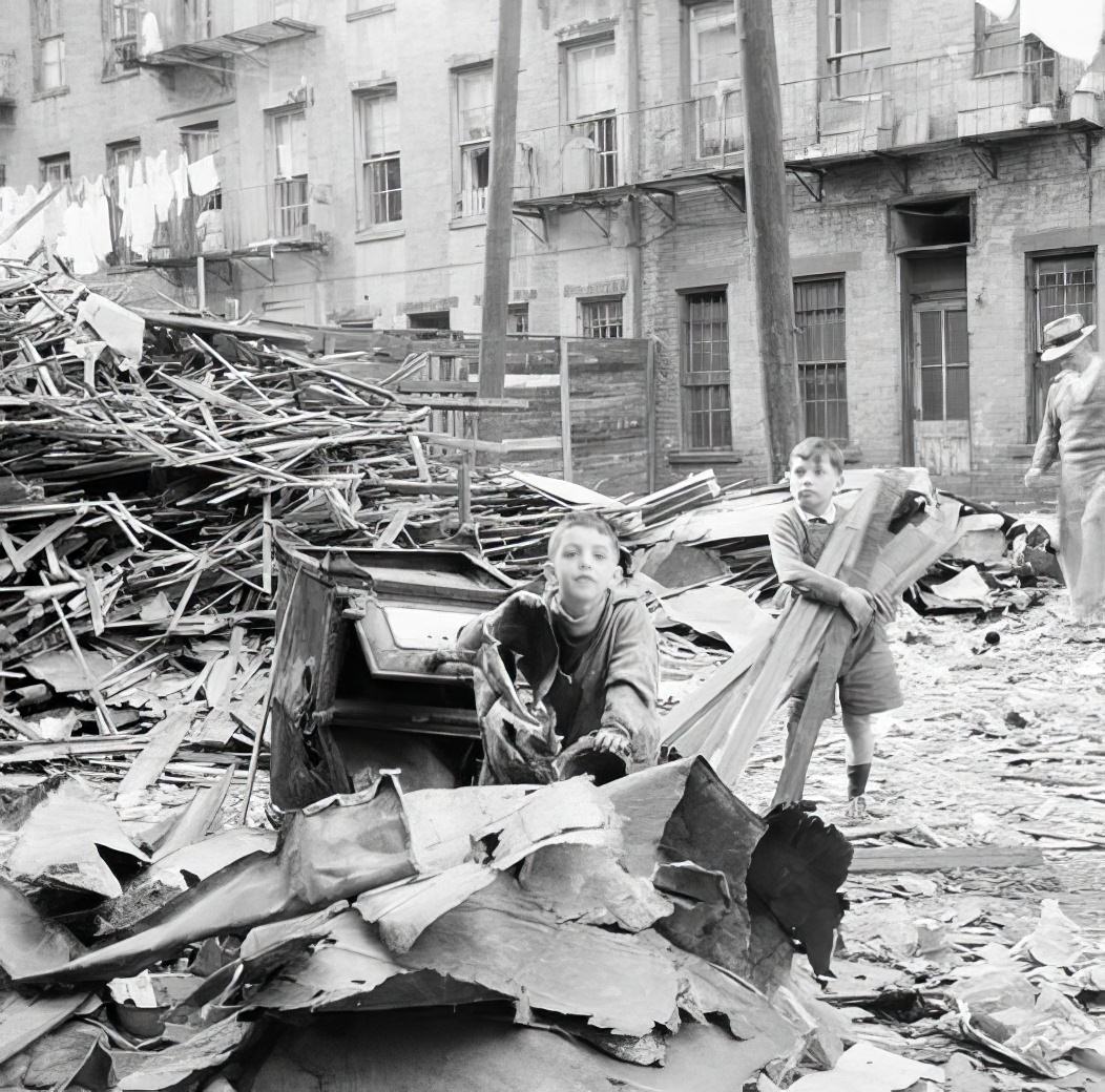 Boys gathering wood from wreckage, 1936.