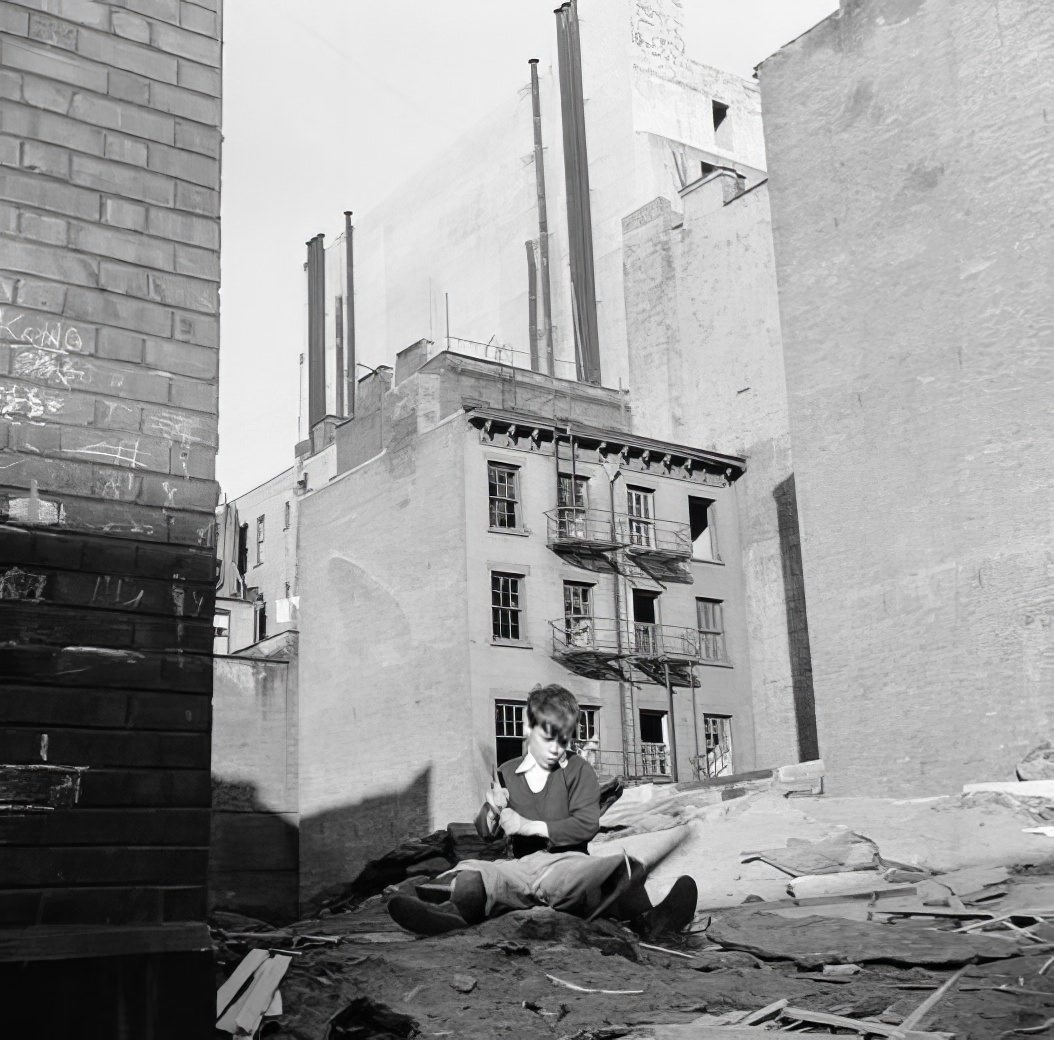 Boy playing in junk, 1936.