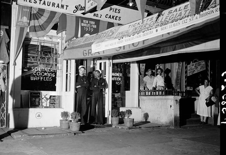 Two sailors in the doorway of a restaurant, 7th Ave., 1939.