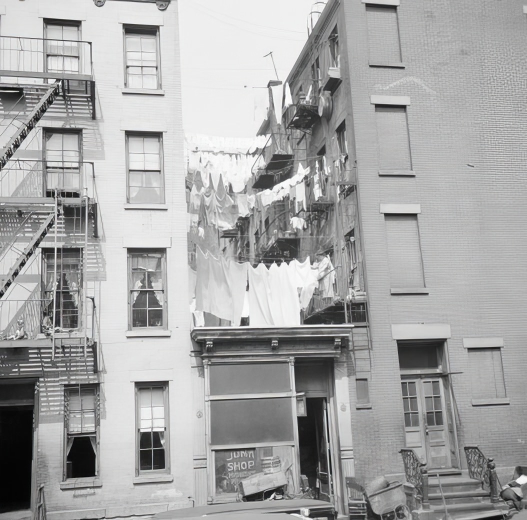 Junk store between tenements, 1935.