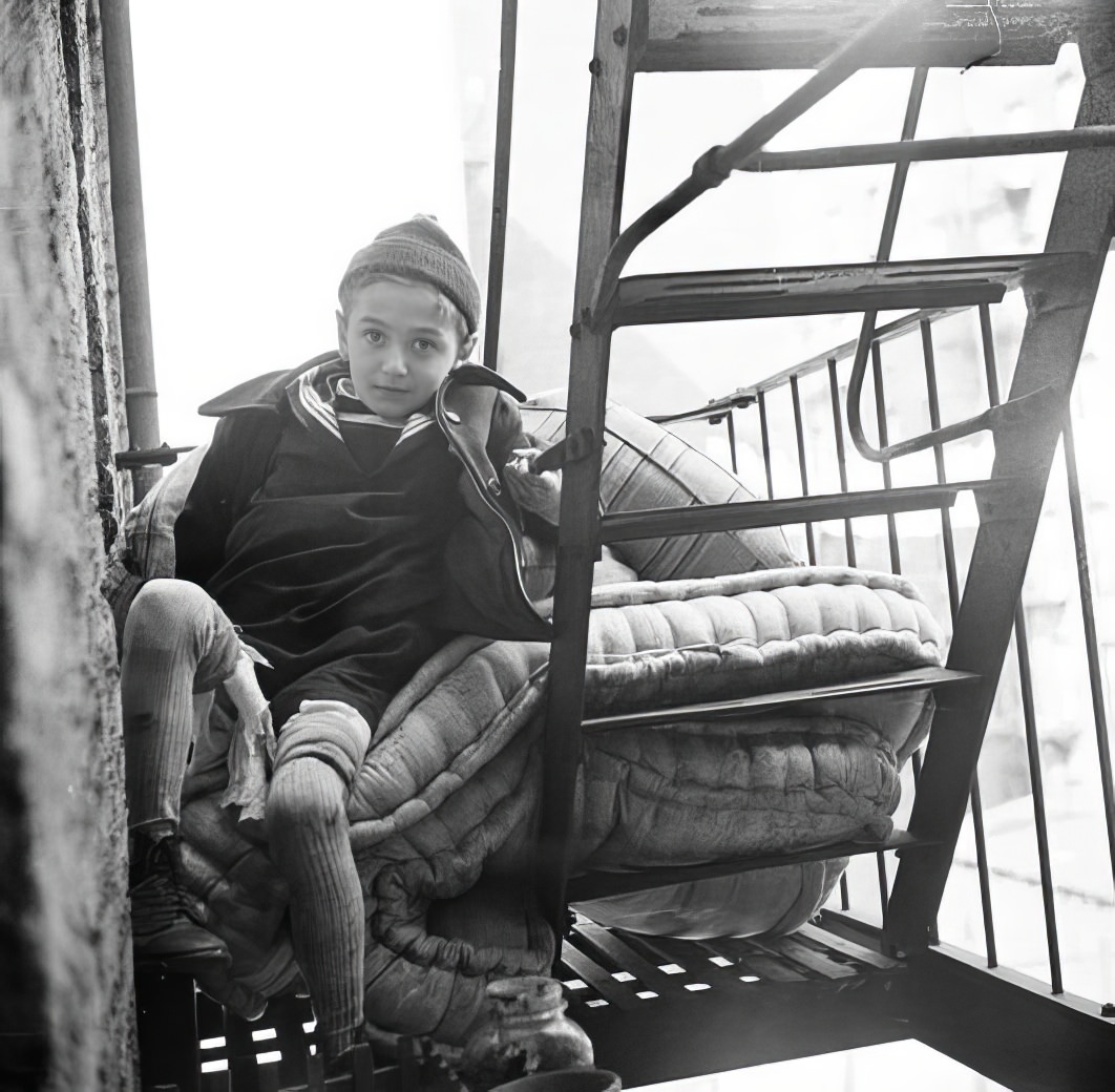 Mattress and boy on fire escape, 1935.