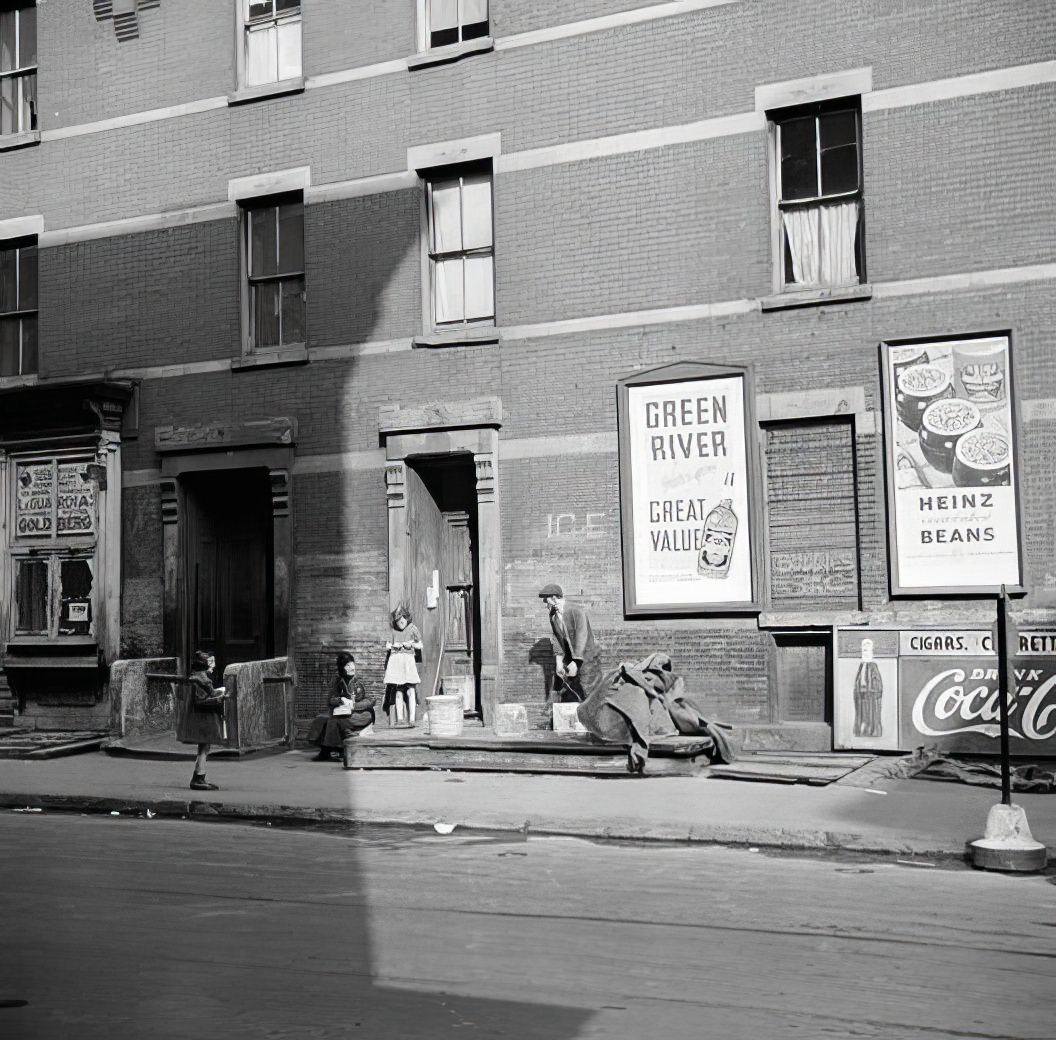 Children on the sidewalk with signs, 1935.