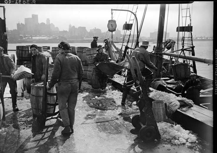 Fulton Fish Market: Unloading fish, 1938.