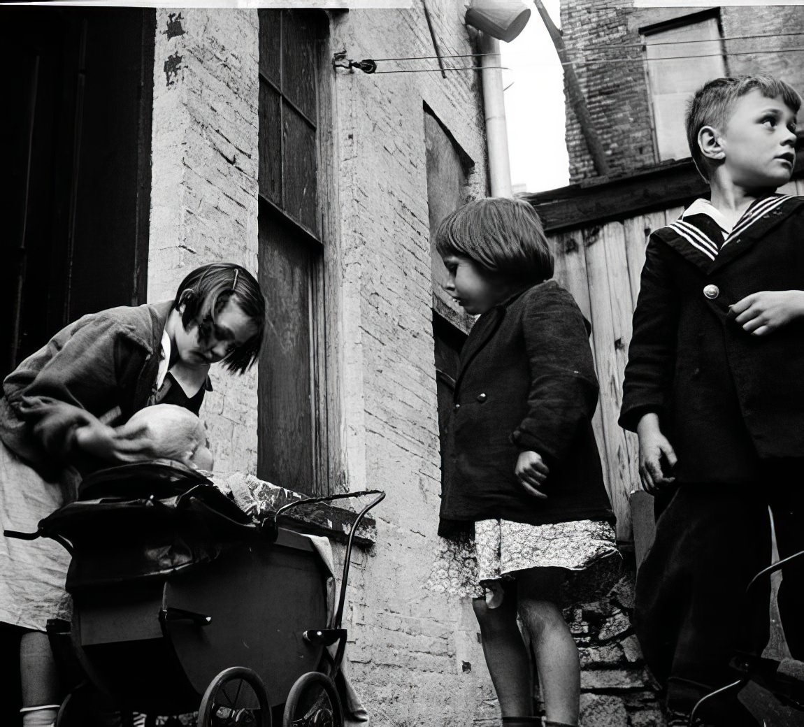 Children and baby in the street, 1936.