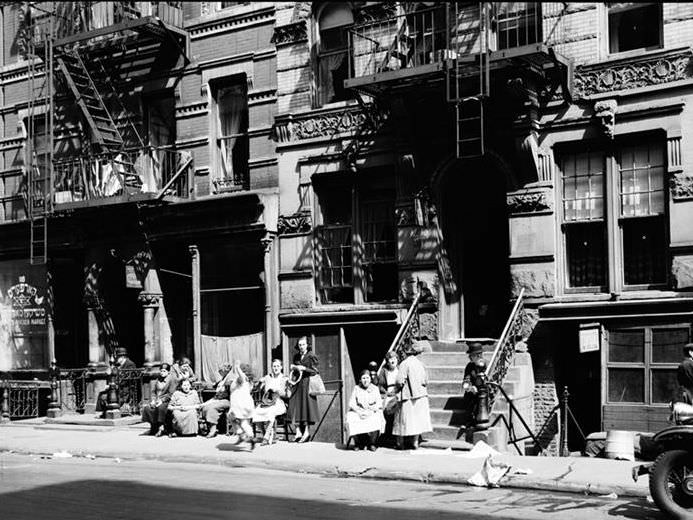 People sitting on stoops, 1936.