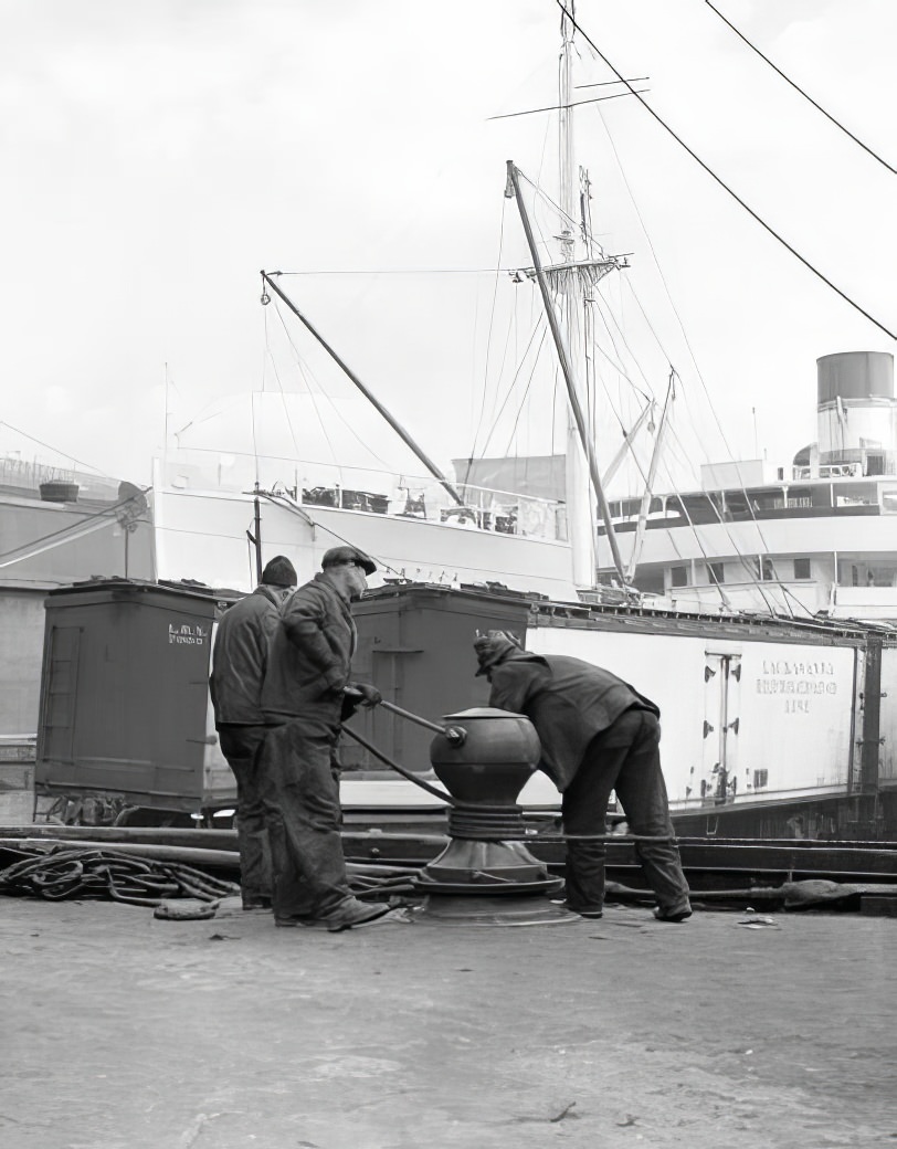 Waterfront scene: docking a boat, May 1937.