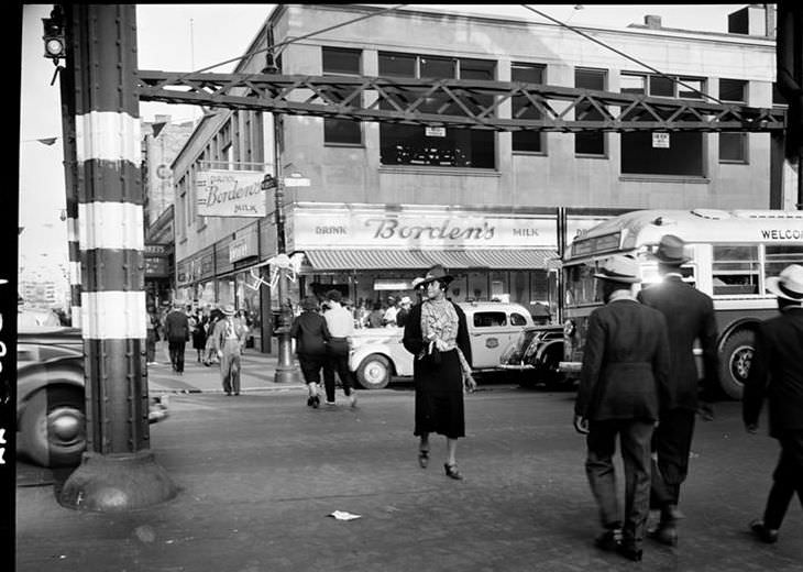 Street scene with Borden's Milk sign, 1940.