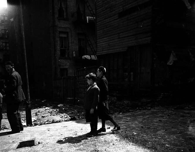 Two boys and a man in a courtyard, 1935.