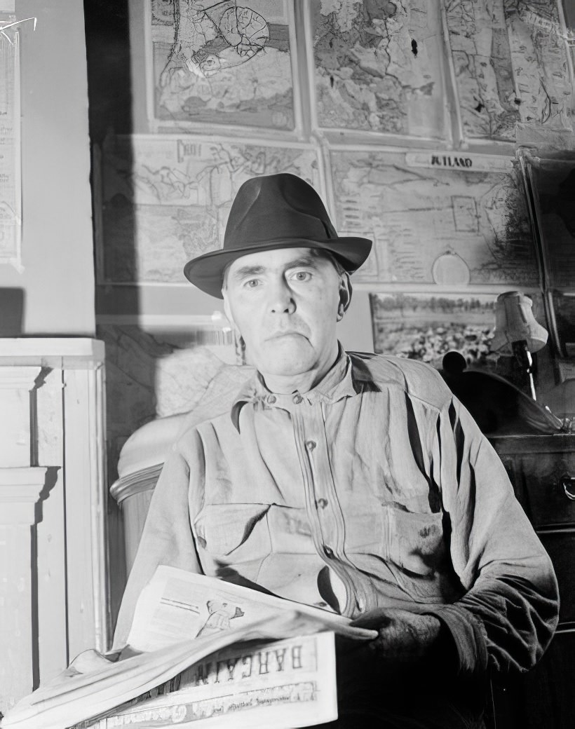 Close-up of man with maps on the wall, 1935.