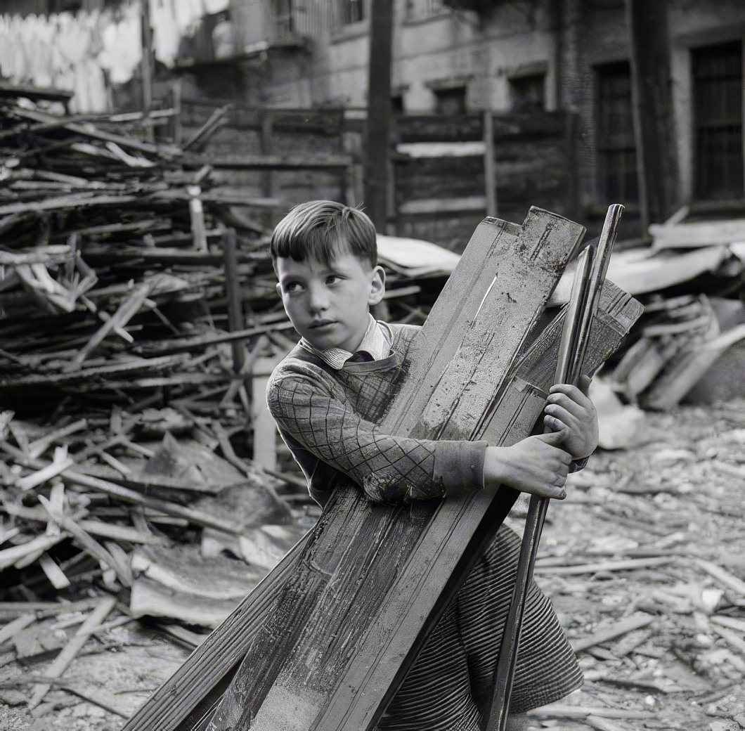 Boy with armload of old lumber, 1935.