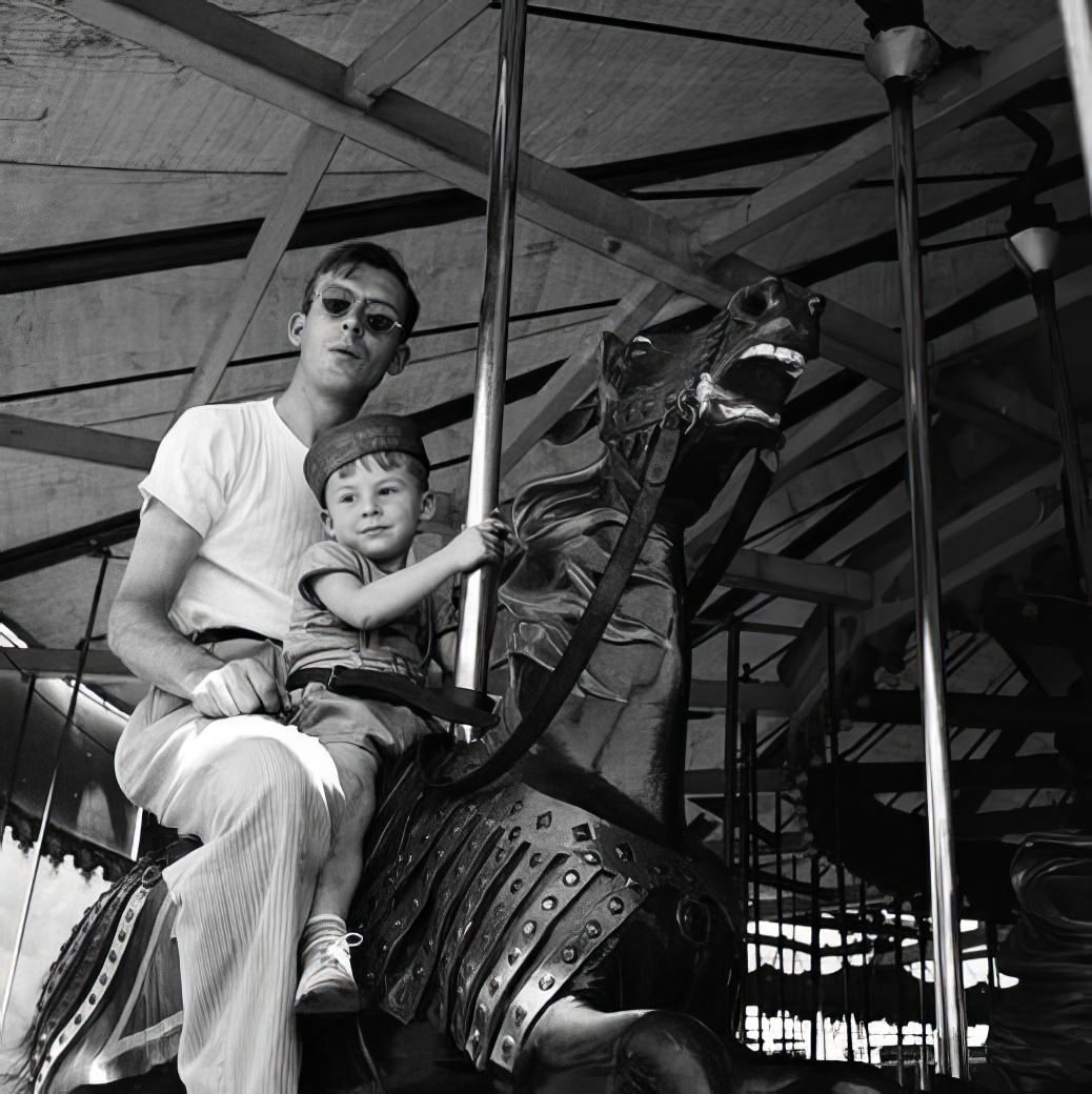 Merry-go-round: father and son, July 1940.