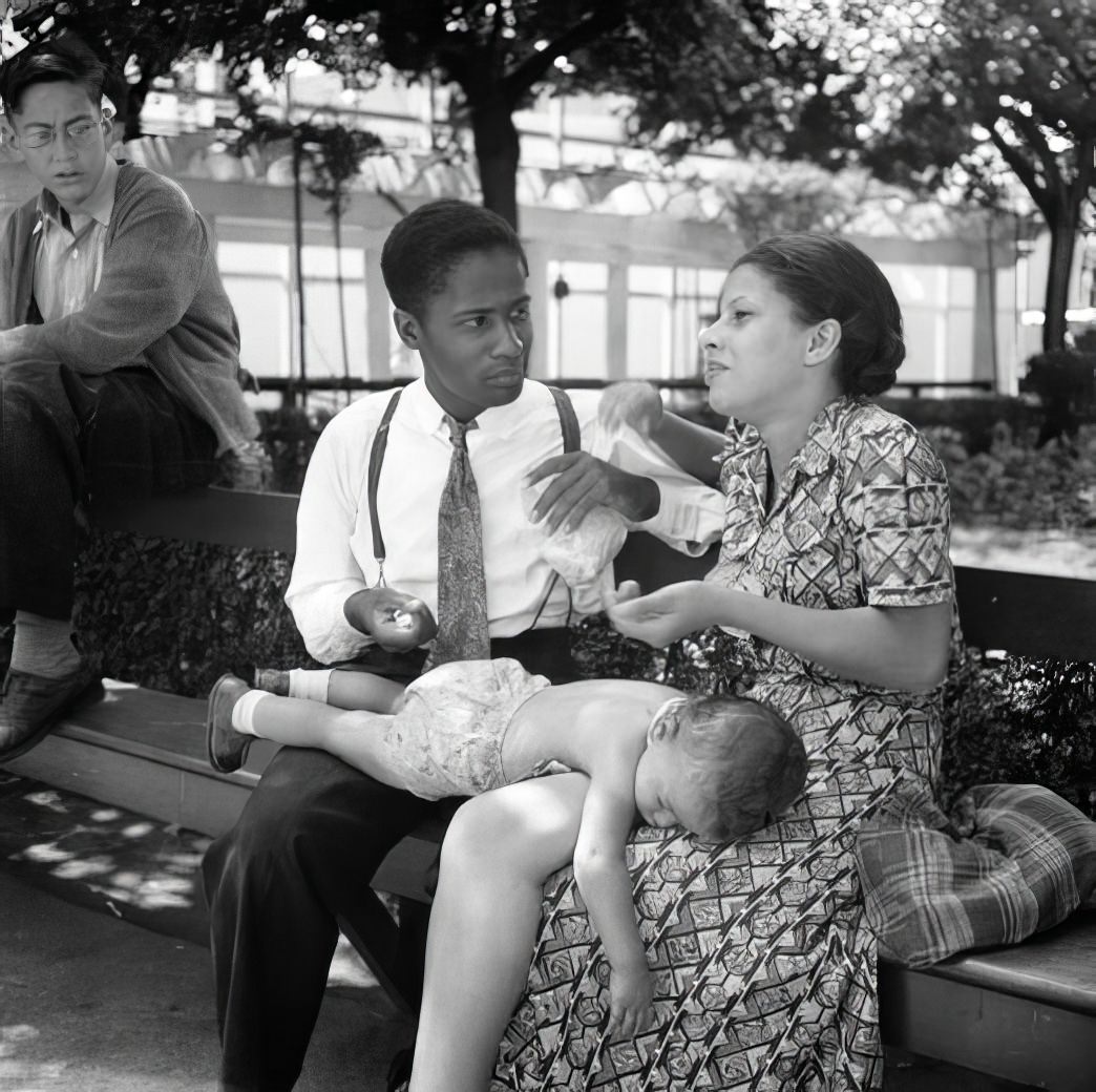 Steeplechase: couple with baby on a bench, July 1939.