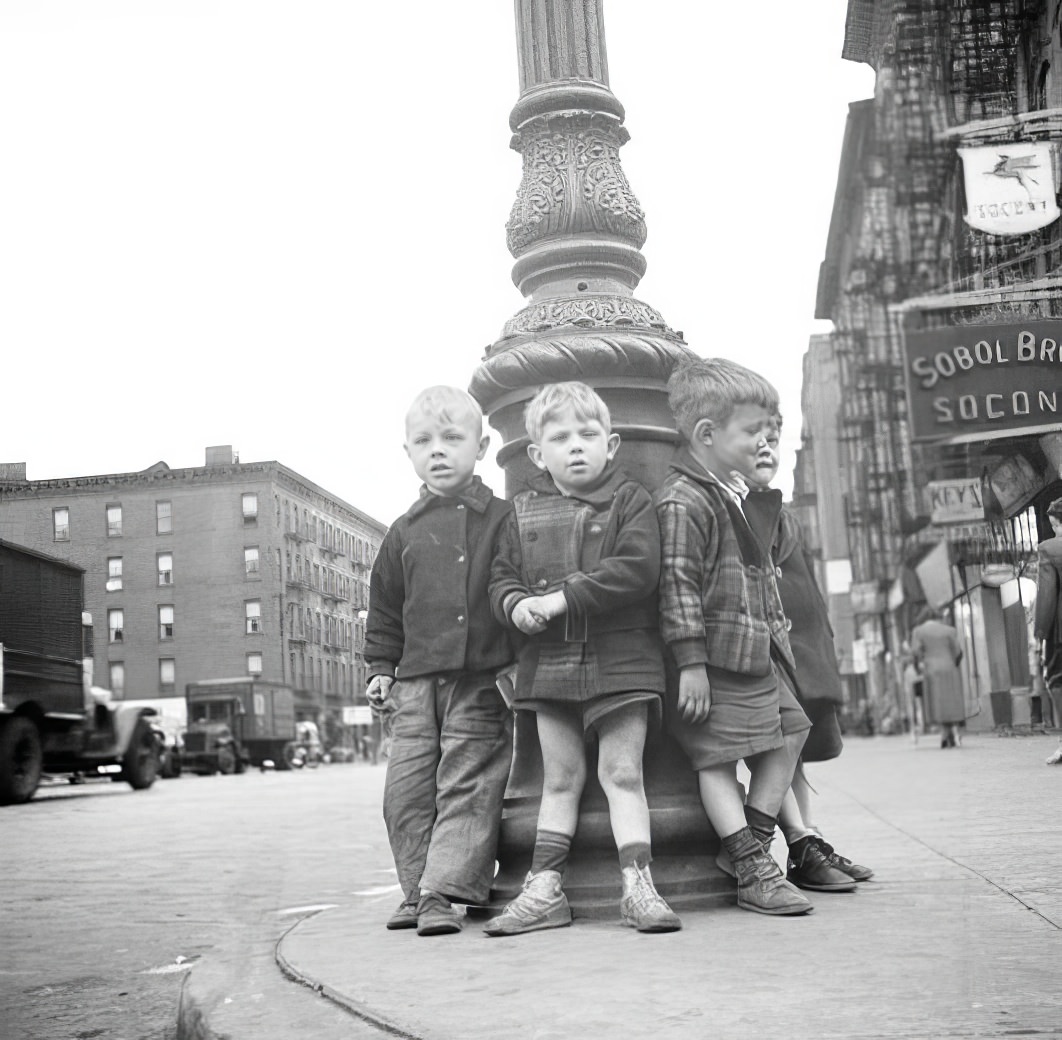 Little boys leaning against lamppost, 1936.