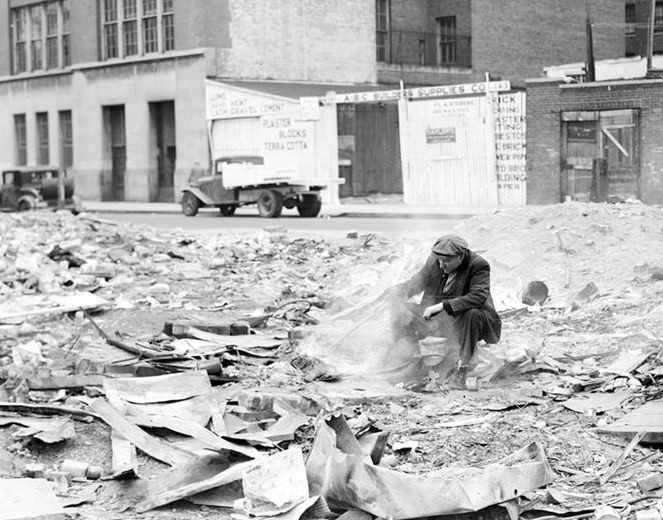 Man cooking in junk lot, 1936.