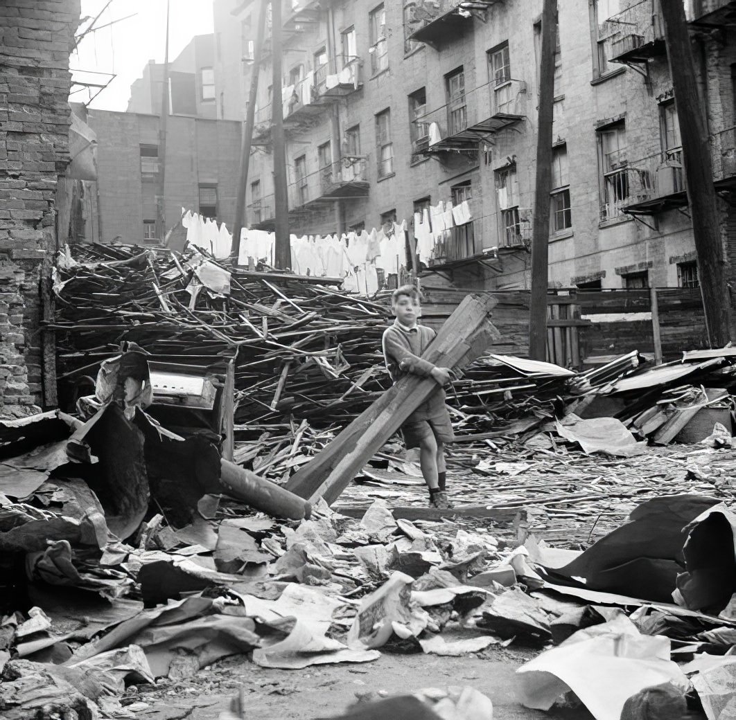 Boy with boards amidst wreckage, 1935.