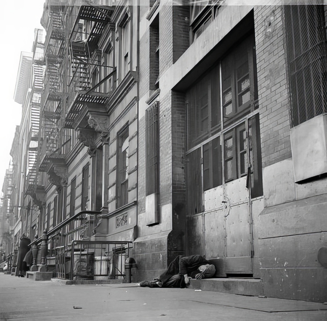 Man lying on sidewalk, 1936.